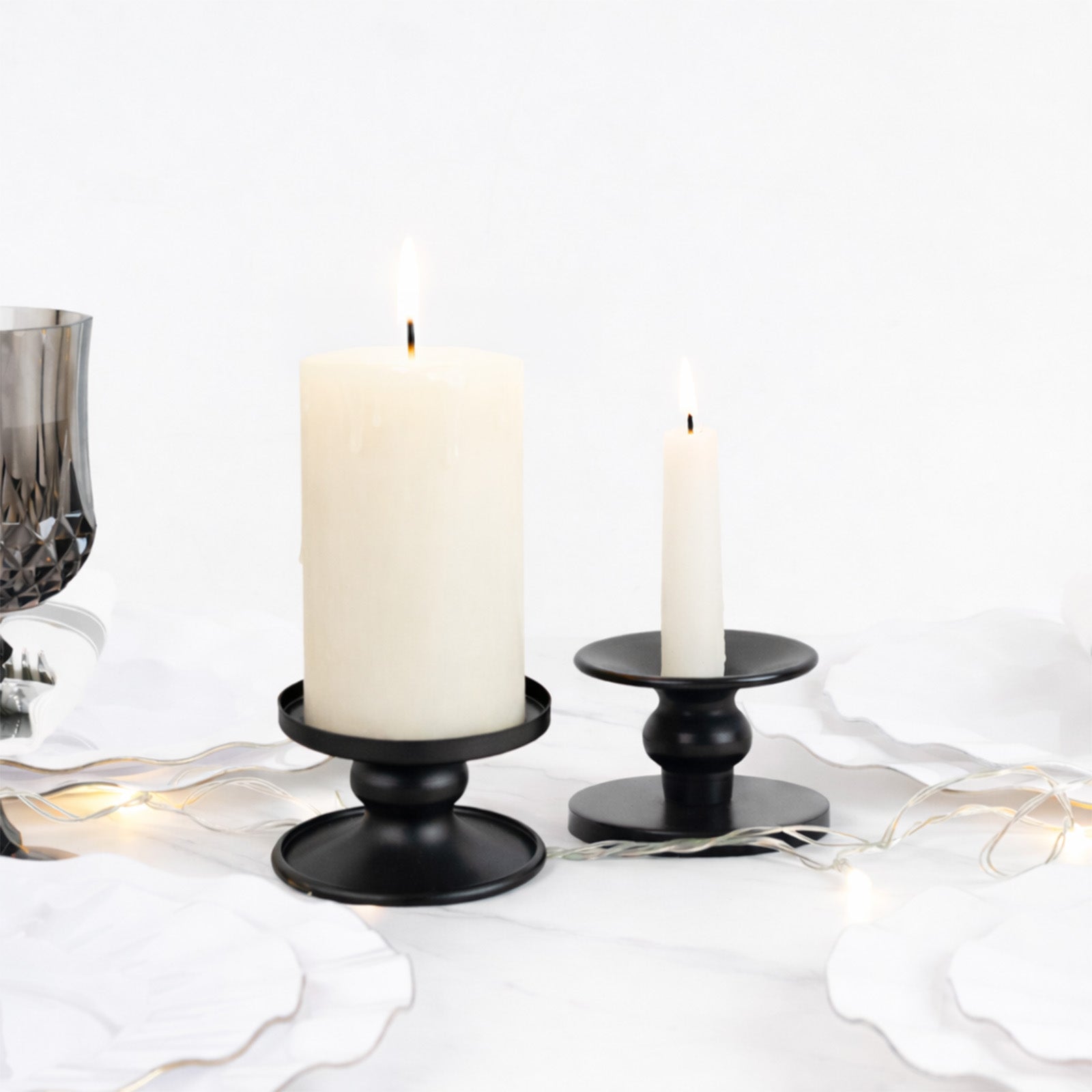 Black metal candle holders, reversible pillar and taper stands.