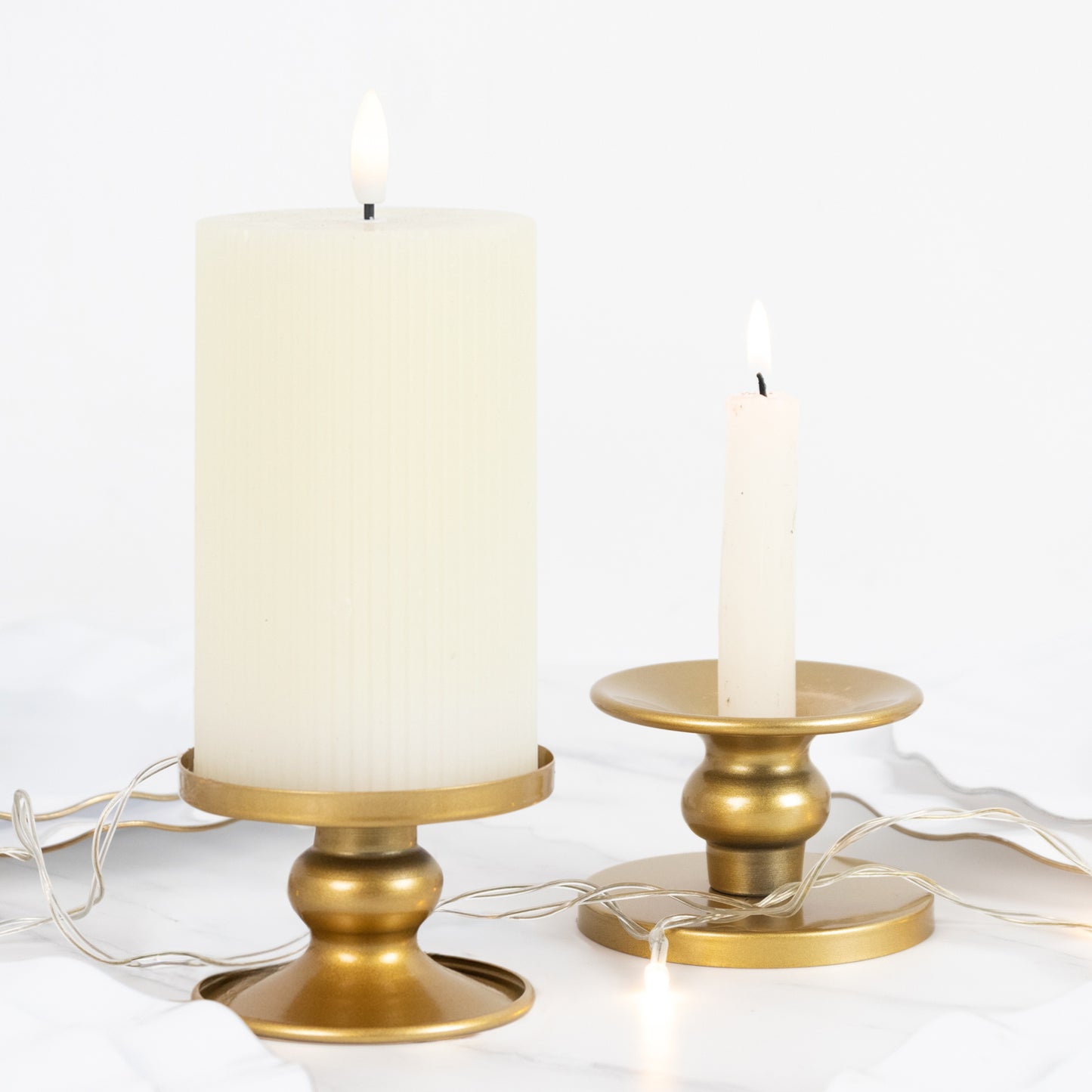 Gold metal candle holders for pillar and taper candles.