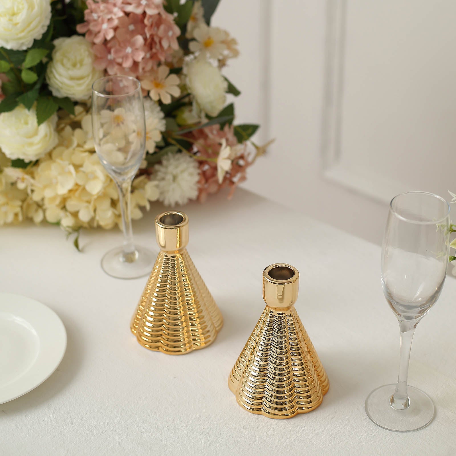 Metallic gold ribbed ceramic taper candle holders, cone shaped.