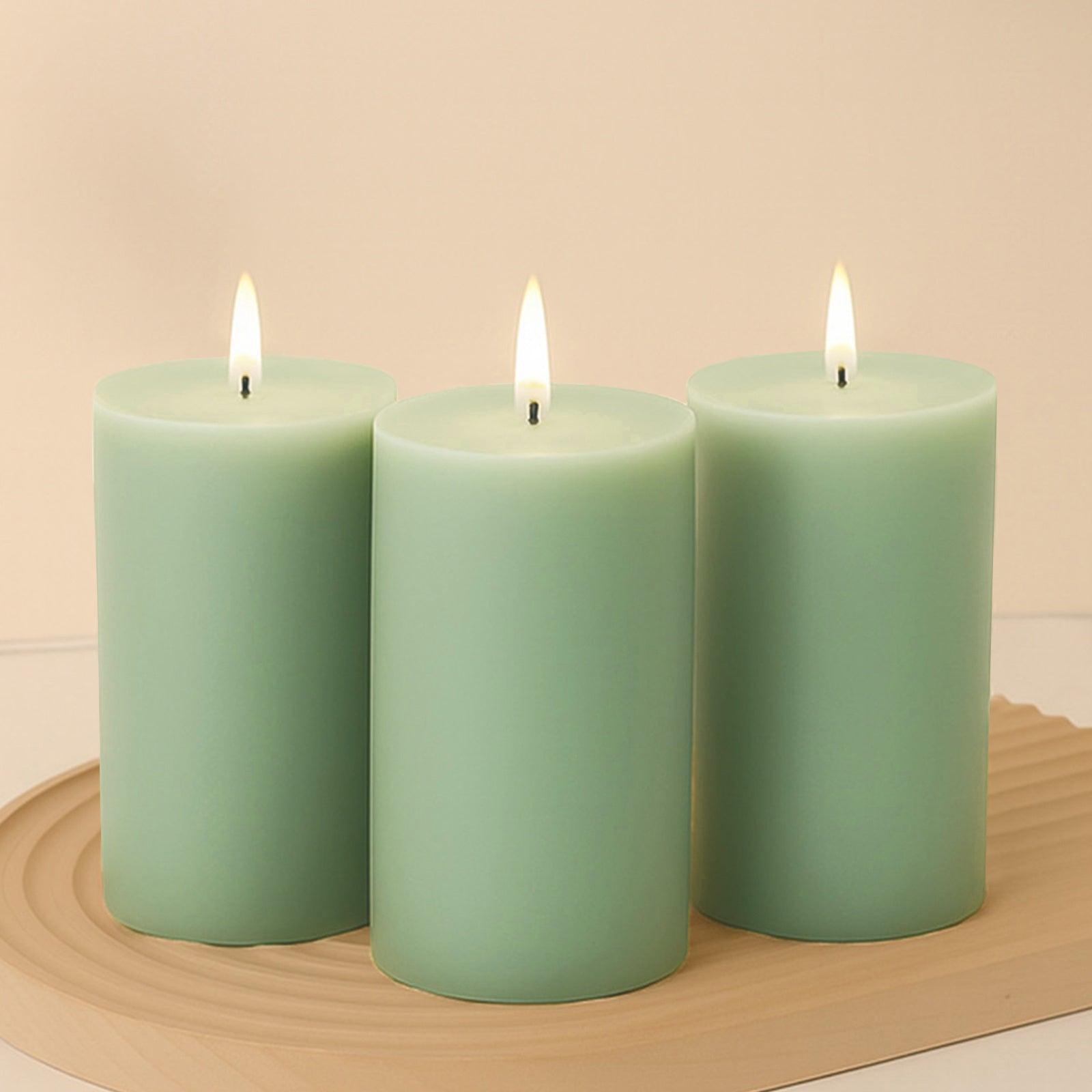 Sage green unscented dripless pillar candles with clean flames.