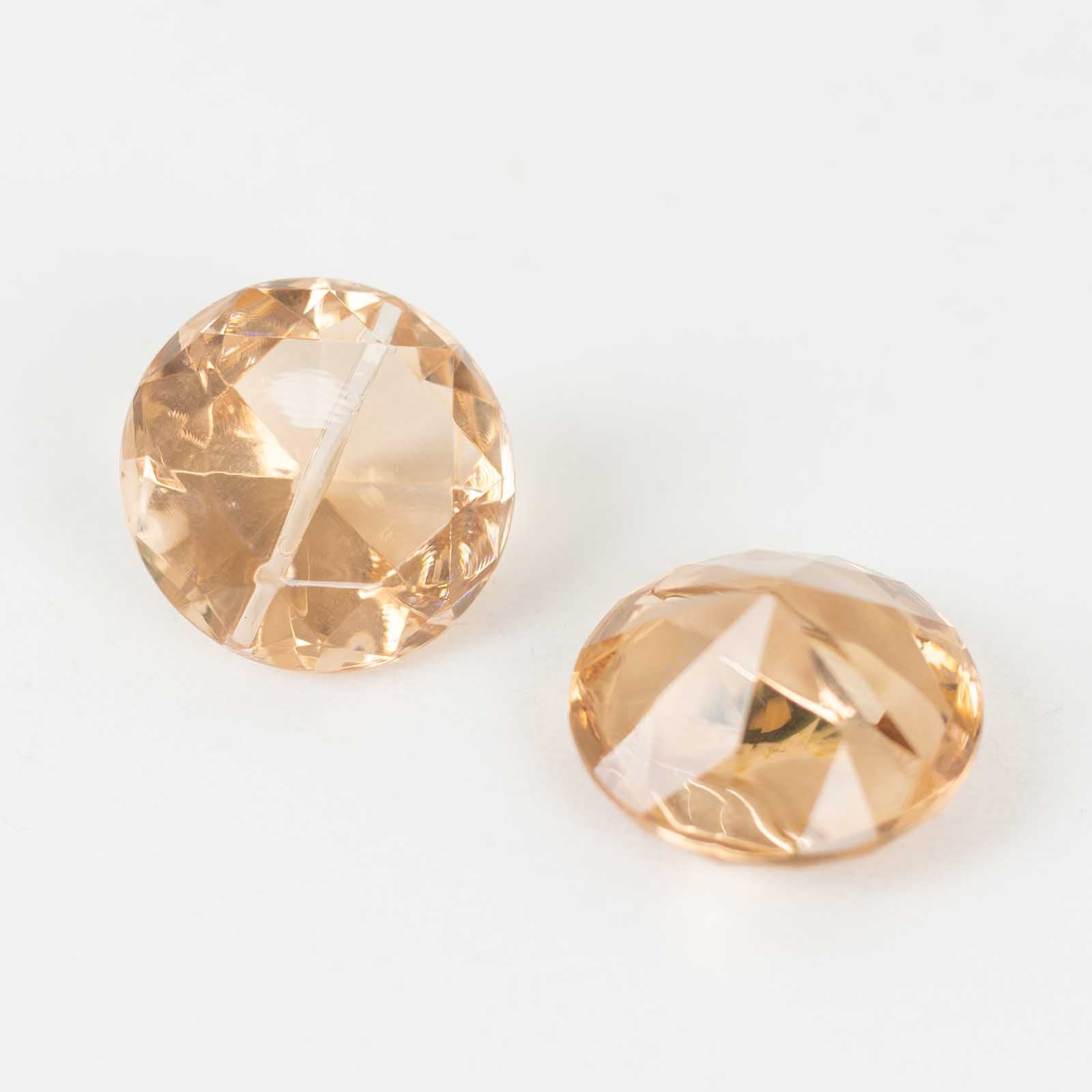 Amber diamond-shaped place card holders for wedding table decorations.