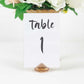 Amber diamond-shaped place card holder stand for wedding table decorations.