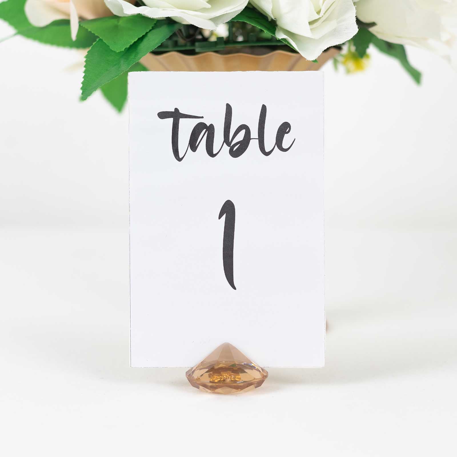 Amber diamond-shaped place card holder stand for wedding table decorations.