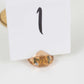 Amber diamond-shaped place card holder for wedding table decorations.