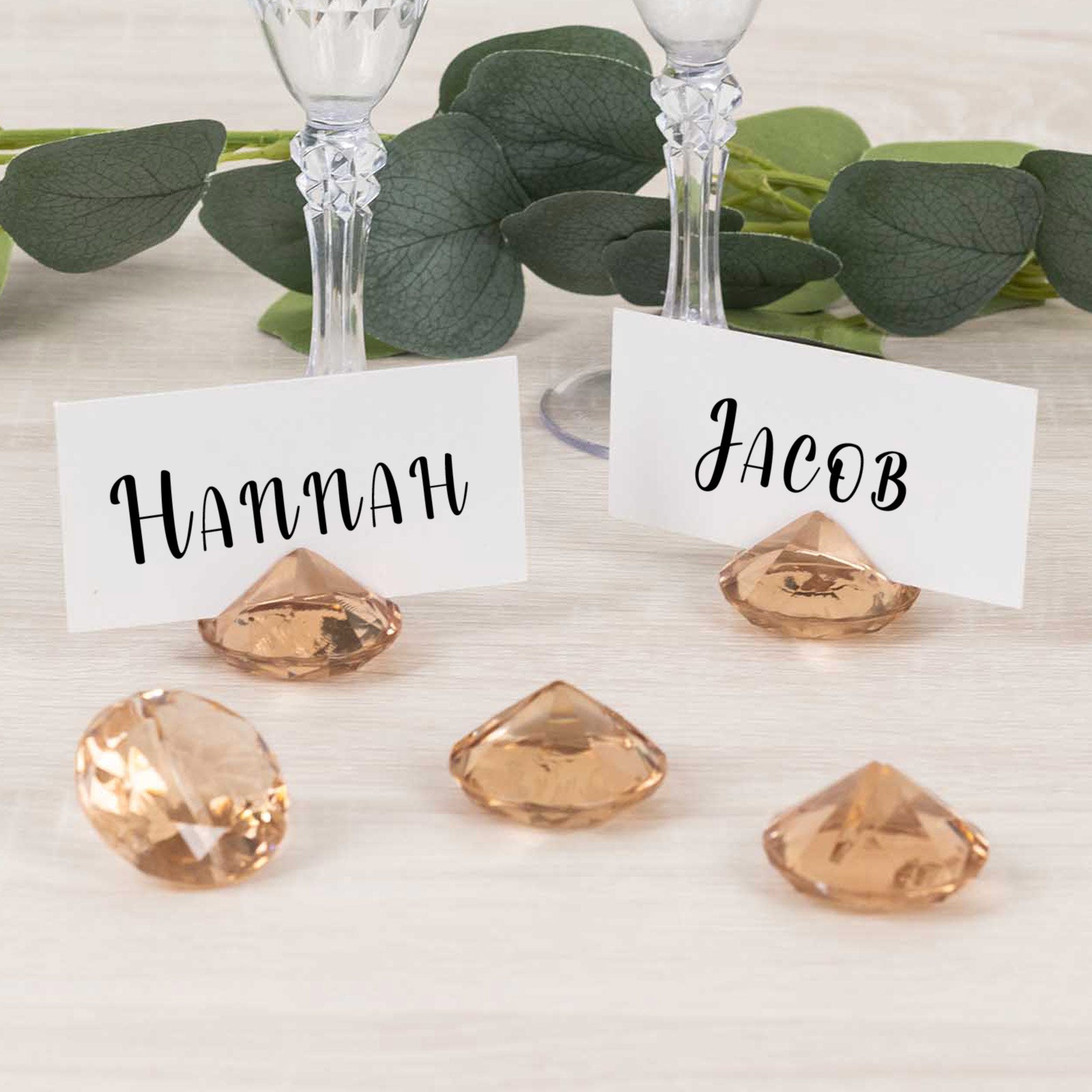 Amber diamond-shaped place card holders for wedding table decorations.