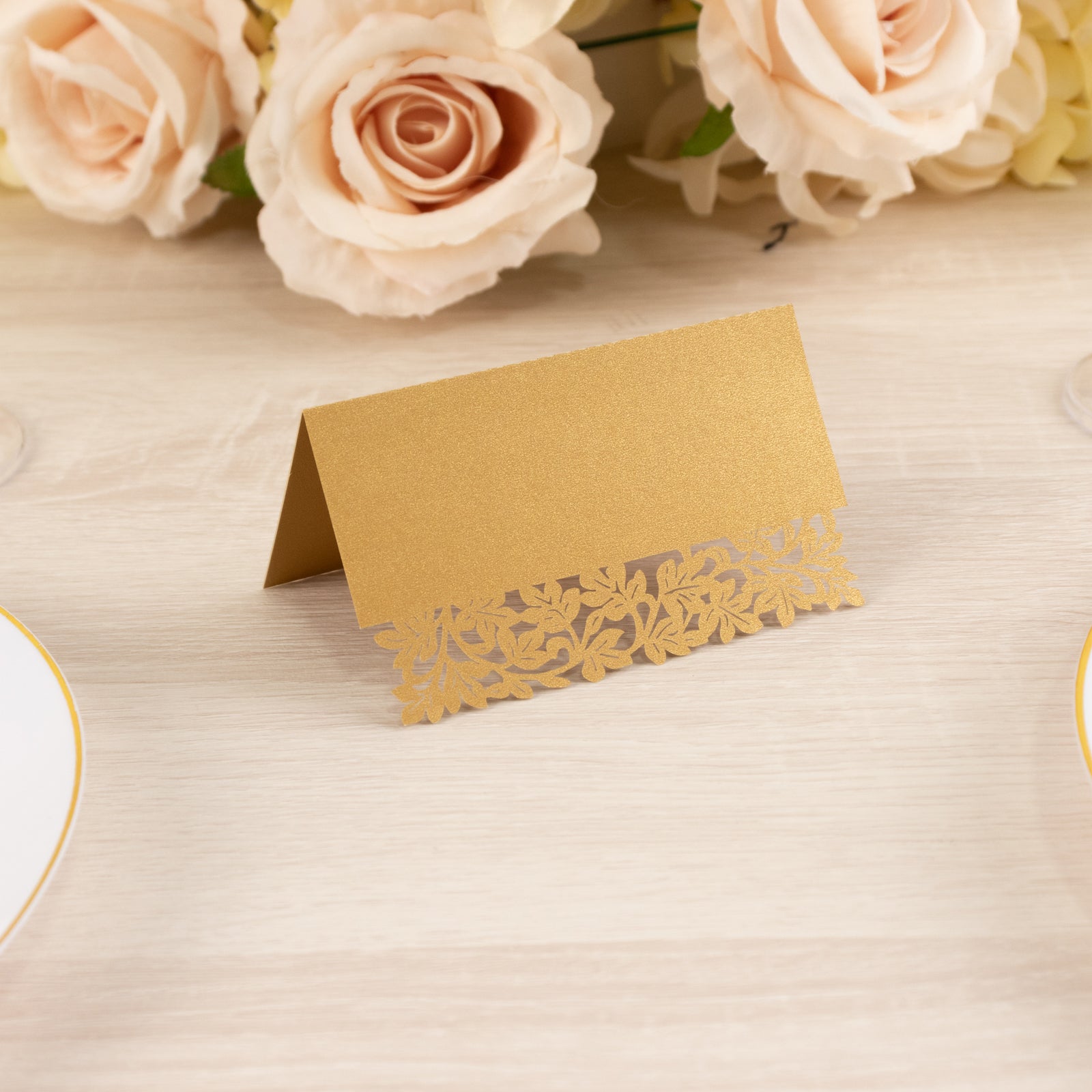 Gold wedding table number card with laser cut leaf vine design.