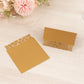 Gold wedding table number cards with laser cut leaf vine design.