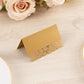 Gold wedding table number card with laser cut leaf vine design.
