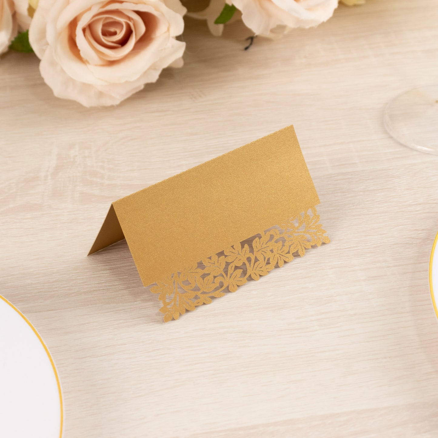Gold wedding table number card with laser cut leaf vine design.