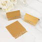 Gold wedding table number cards with laser cut leaf vine design.