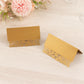 Gold wedding table number cards with laser cut leaf vine design.
