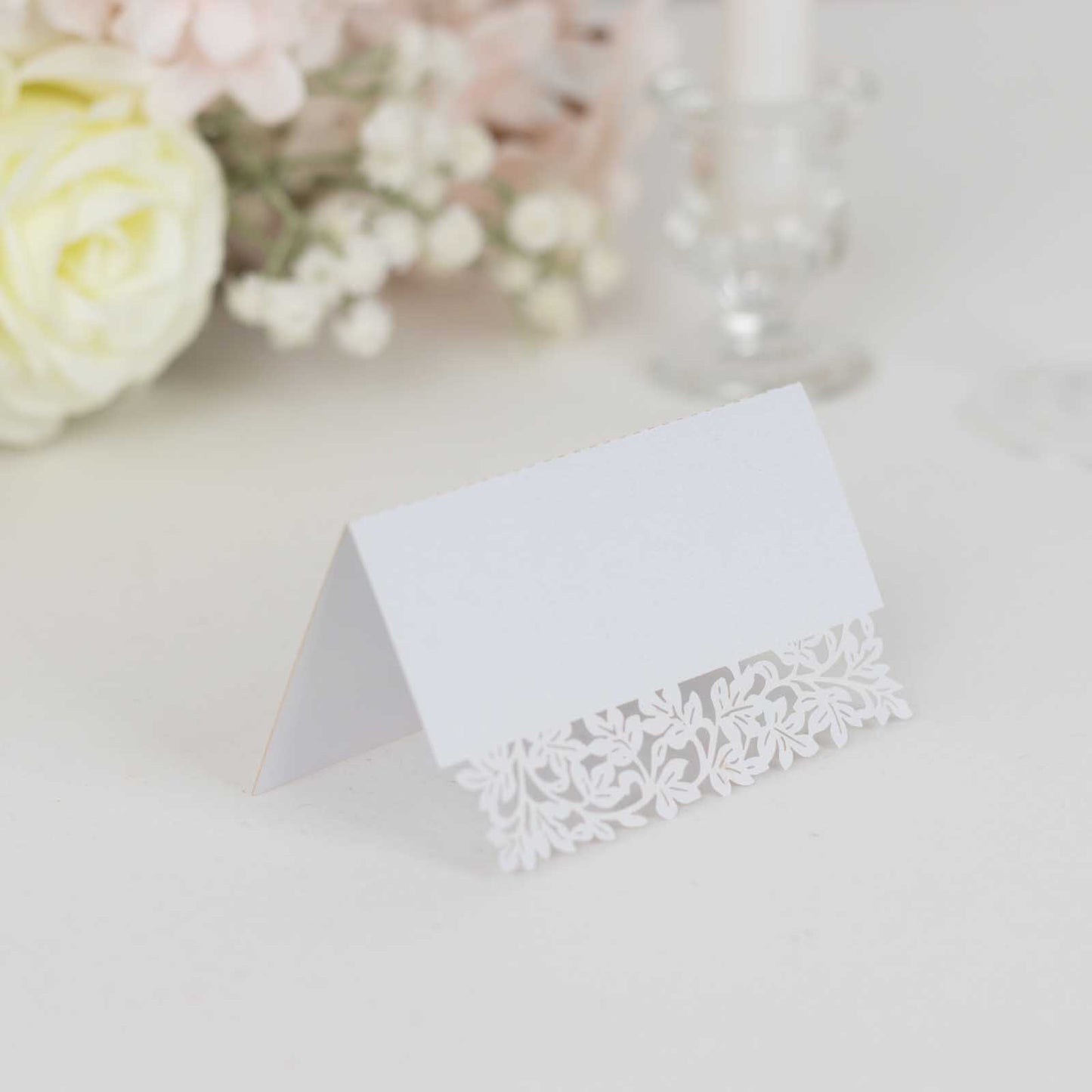 White wedding table number card with laser cut leaf vine design.