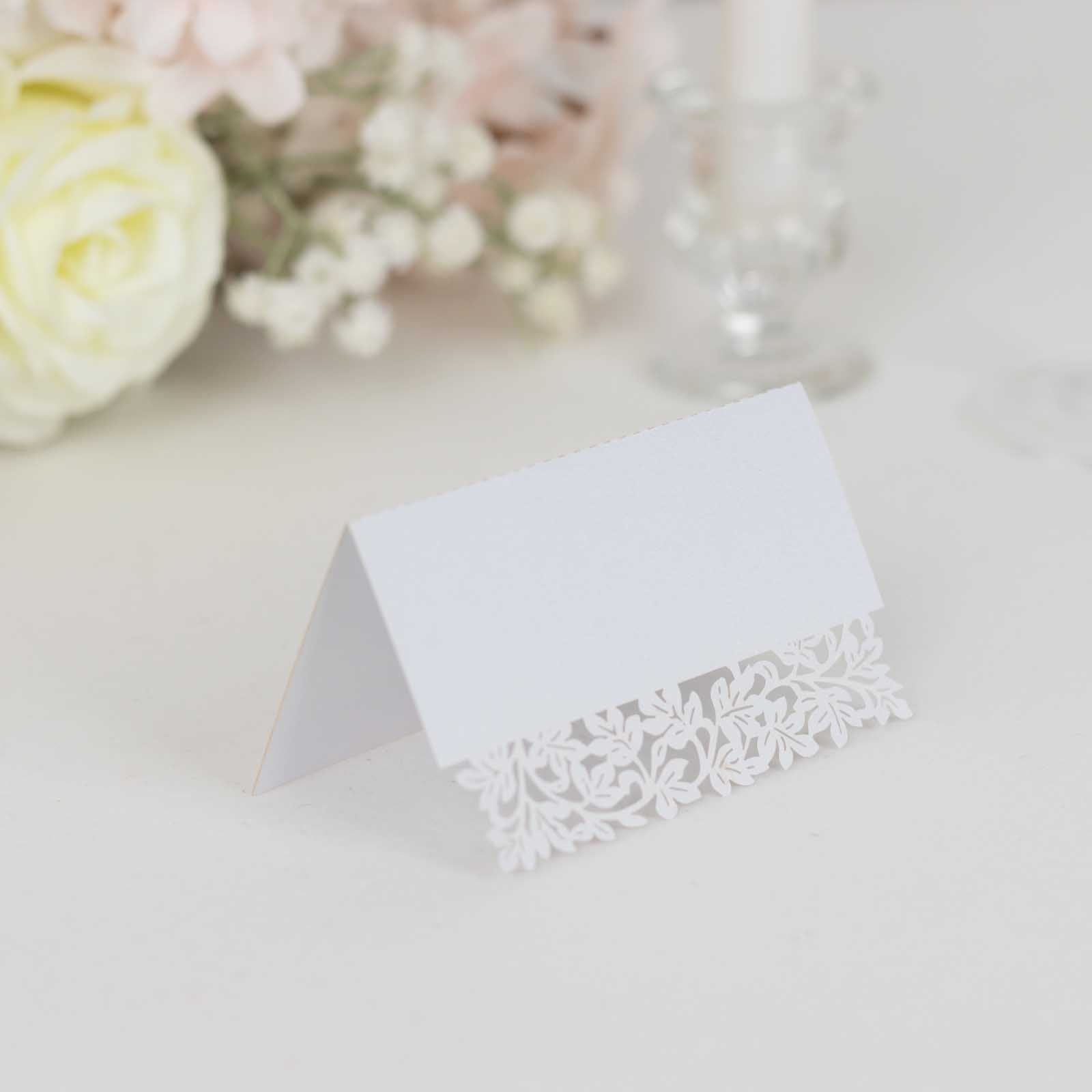 White wedding table number card with laser cut leaf vine design.