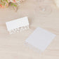 White wedding table number cards with laser cut leaf vine design.