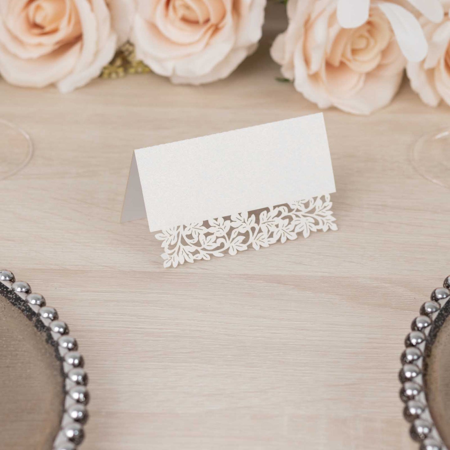 White wedding table number card with laser cut leaf vine design.