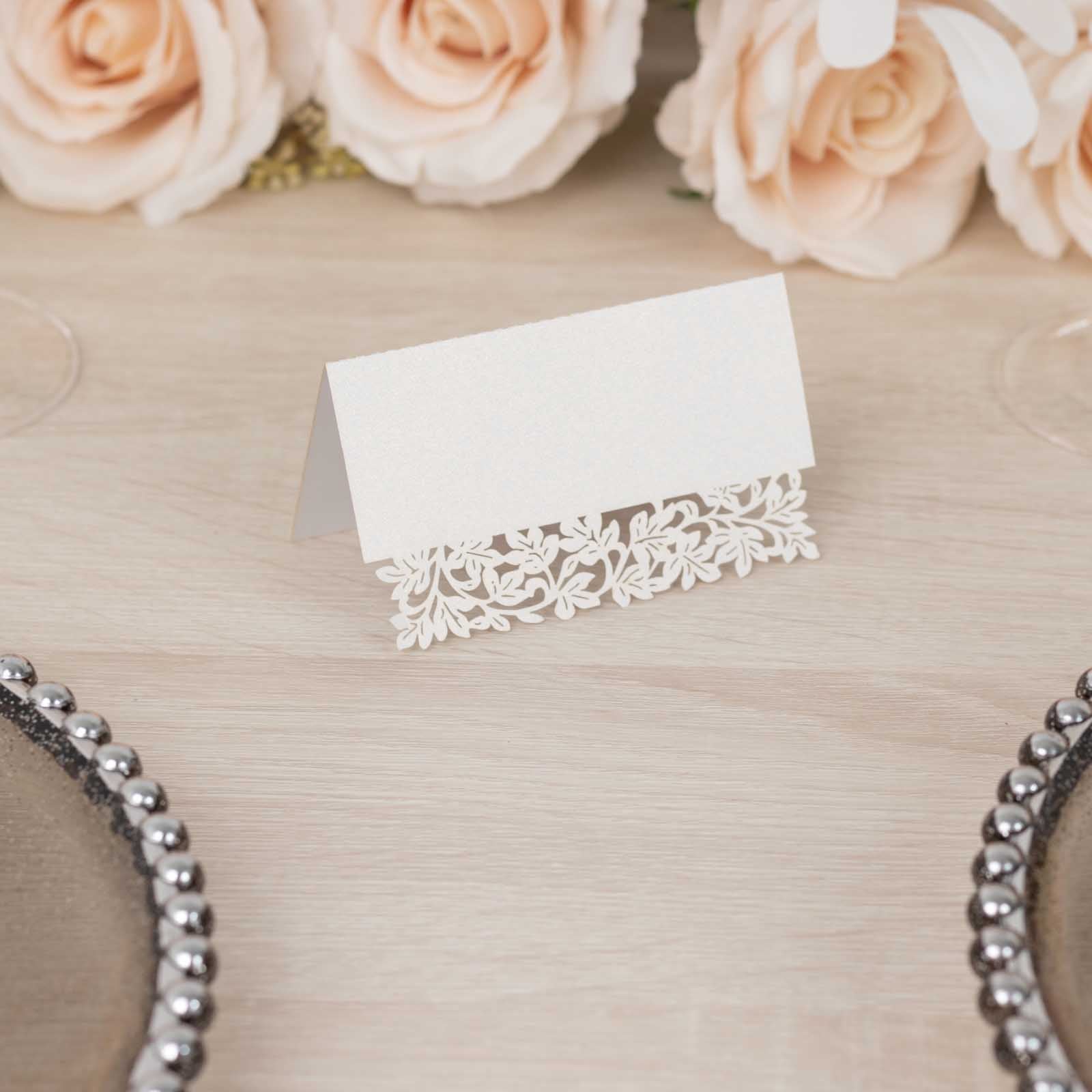 White wedding table number card with laser cut leaf vine design.