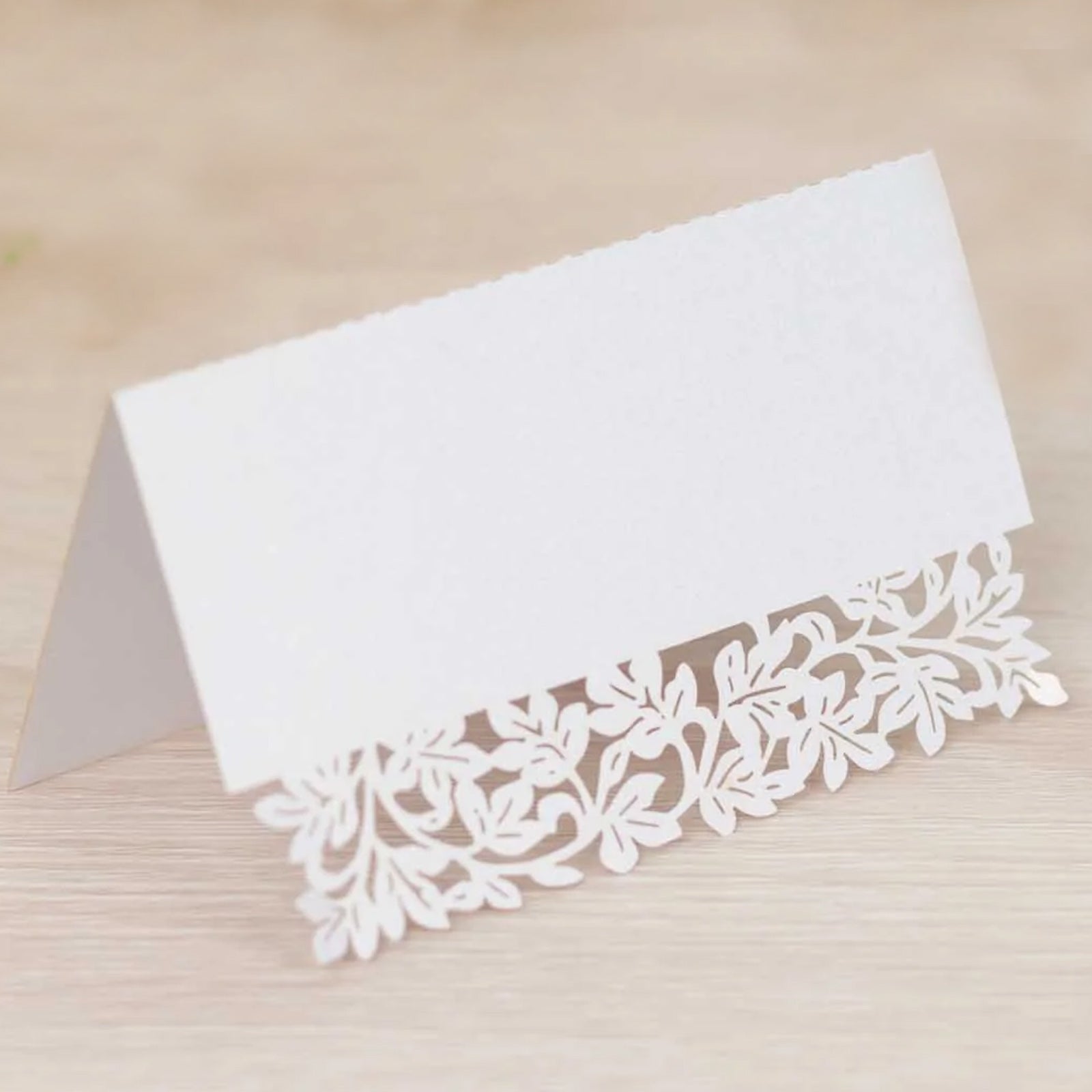 White wedding table number card with laser cut leaf vine design.
