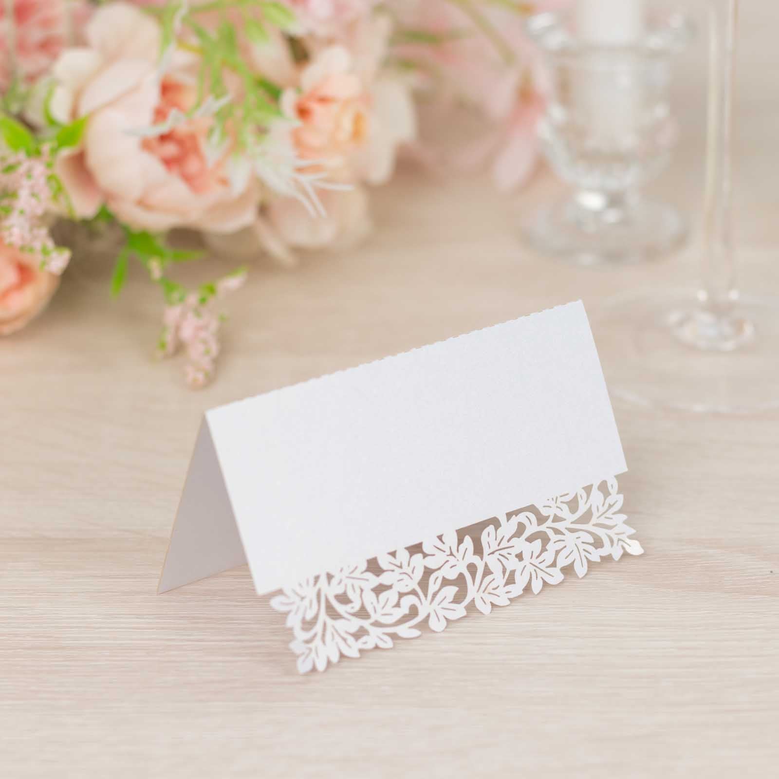 White wedding table number card with laser cut leaf vine design.