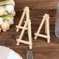 Natural wood mini rustic place card holders on a table setting.