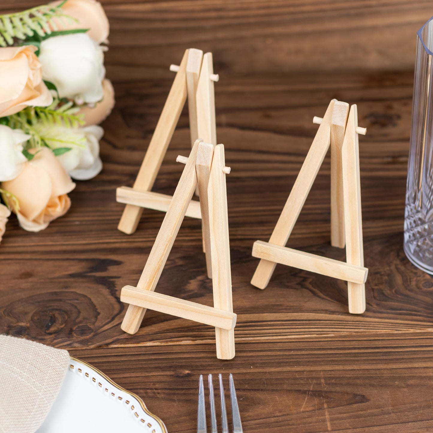 Natural wood mini rustic place card holders on a table setting.