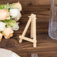 Natural wooden mini easel place card holder on a rustic table setting.