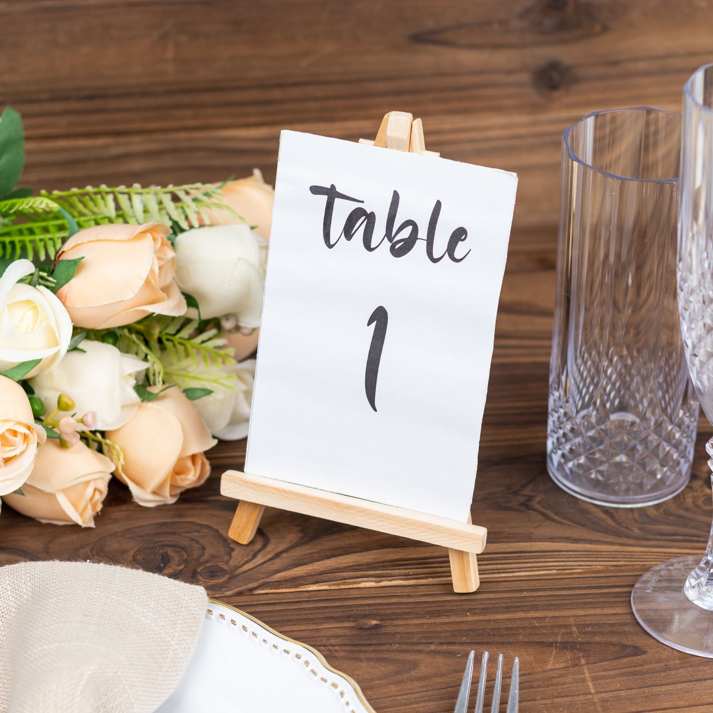 Natural mini rustic place card holder on a wooden table setting.