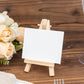 Natural mini rustic wooden place card holder on a table.