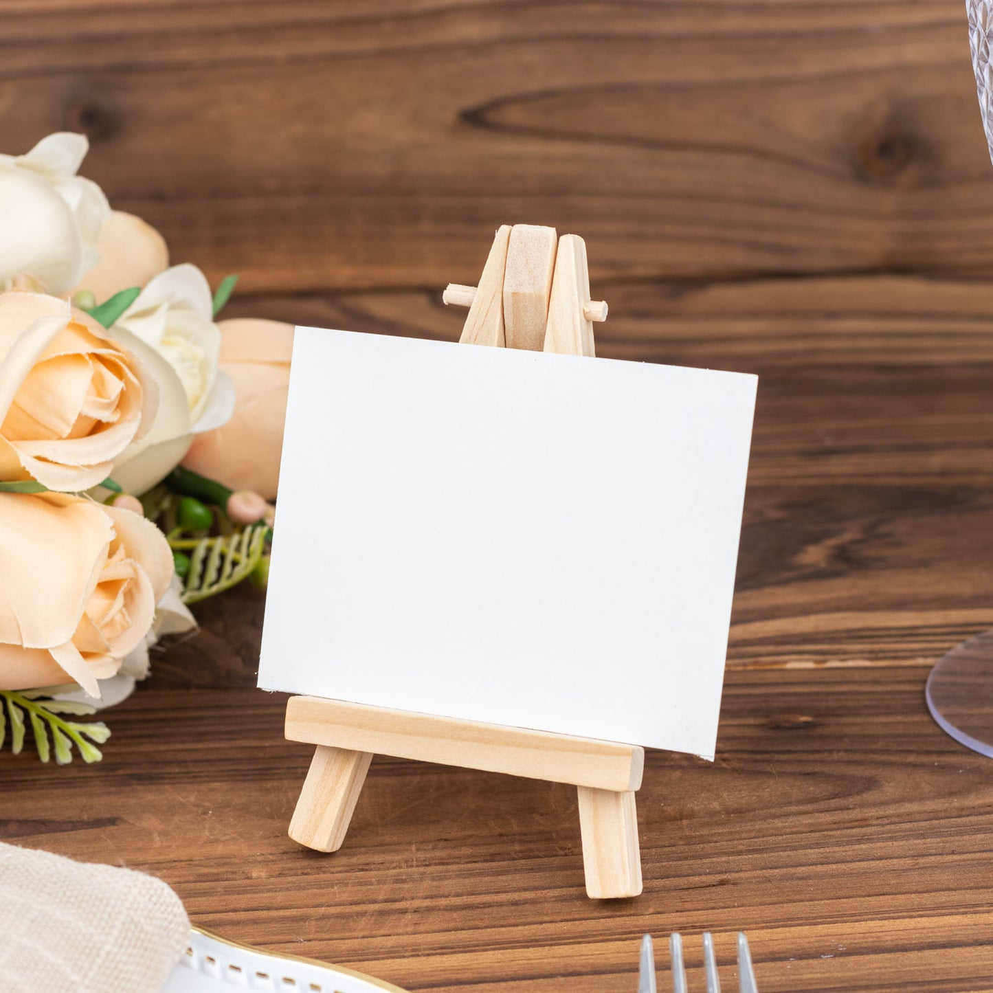 Natural mini rustic wooden place card holder on a table.