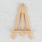 Natural wooden mini easel stands for place cards and table numbers.
