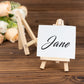 Natural mini rustic wooden place card holder with a name sign displayed.