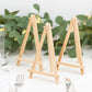 Natural wooden table number holders in a rustic setting.