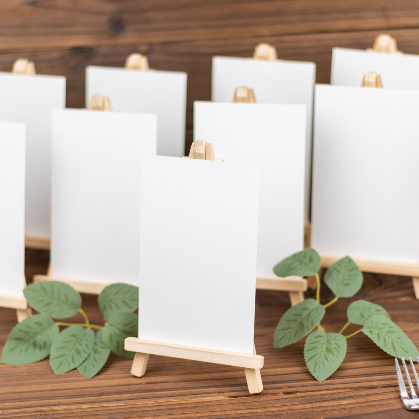 Natural small rustic wooden tabletop easel stands for place cards.