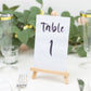 Natural small rustic wooden table number holder with a card displaying "table 1".