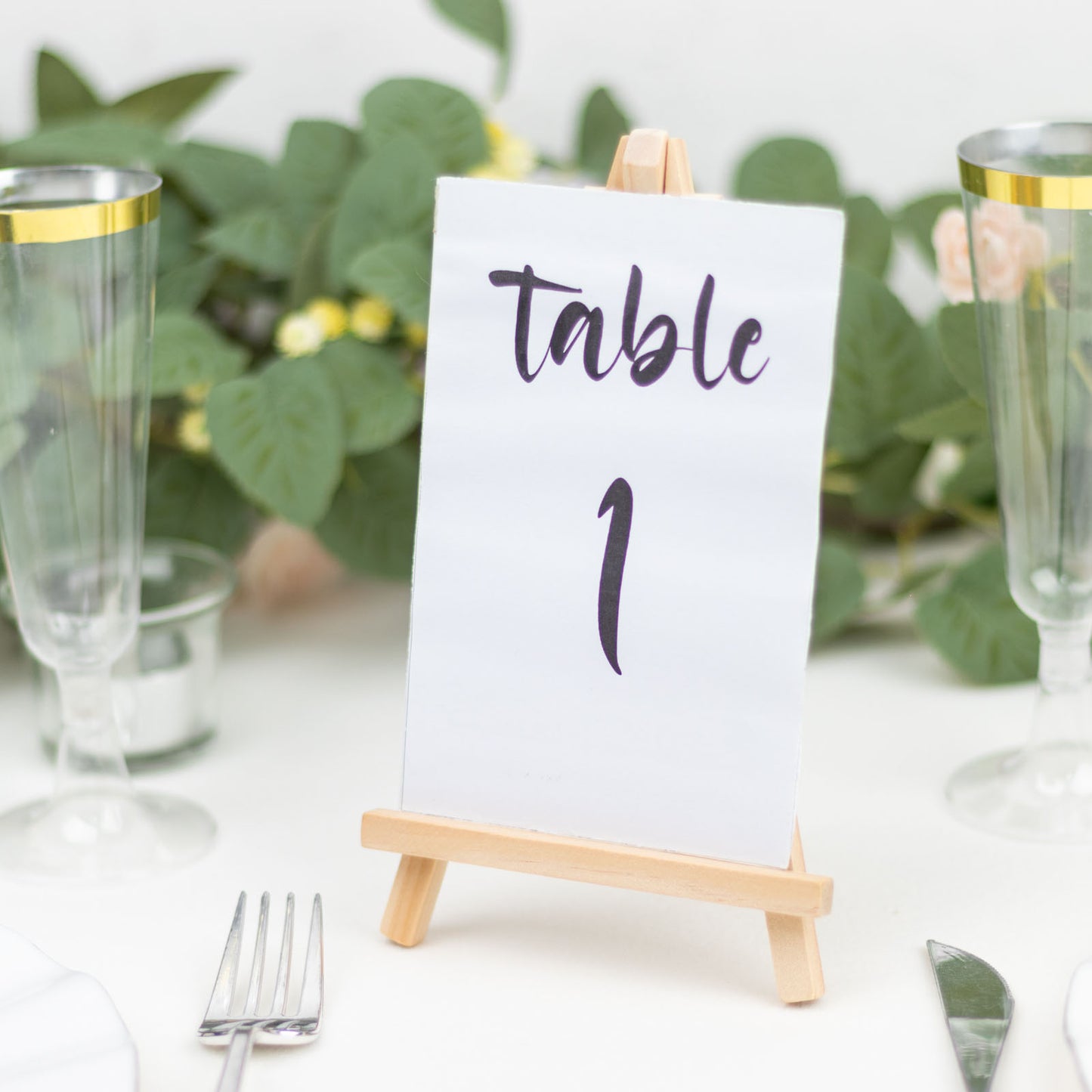 Natural small rustic wooden table number holder with a card displaying "table 1".