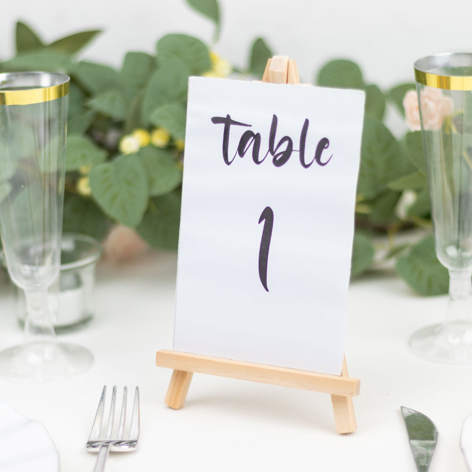 Natural small rustic wooden table number holder with a card displaying "table 1".