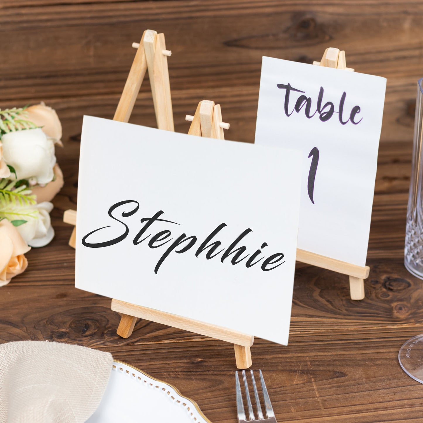 Natural wood rustic place card holders on a table.