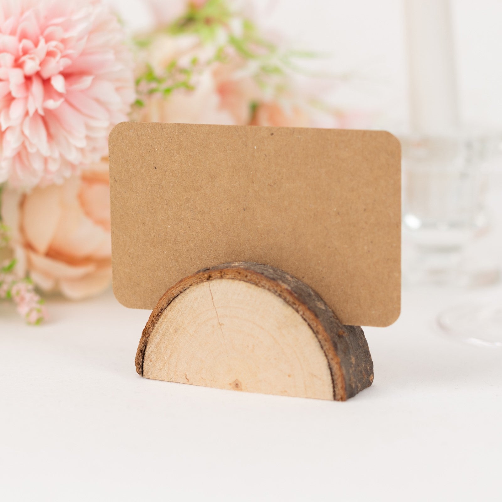Natural wooden semicircle place card holder with brown paper card.