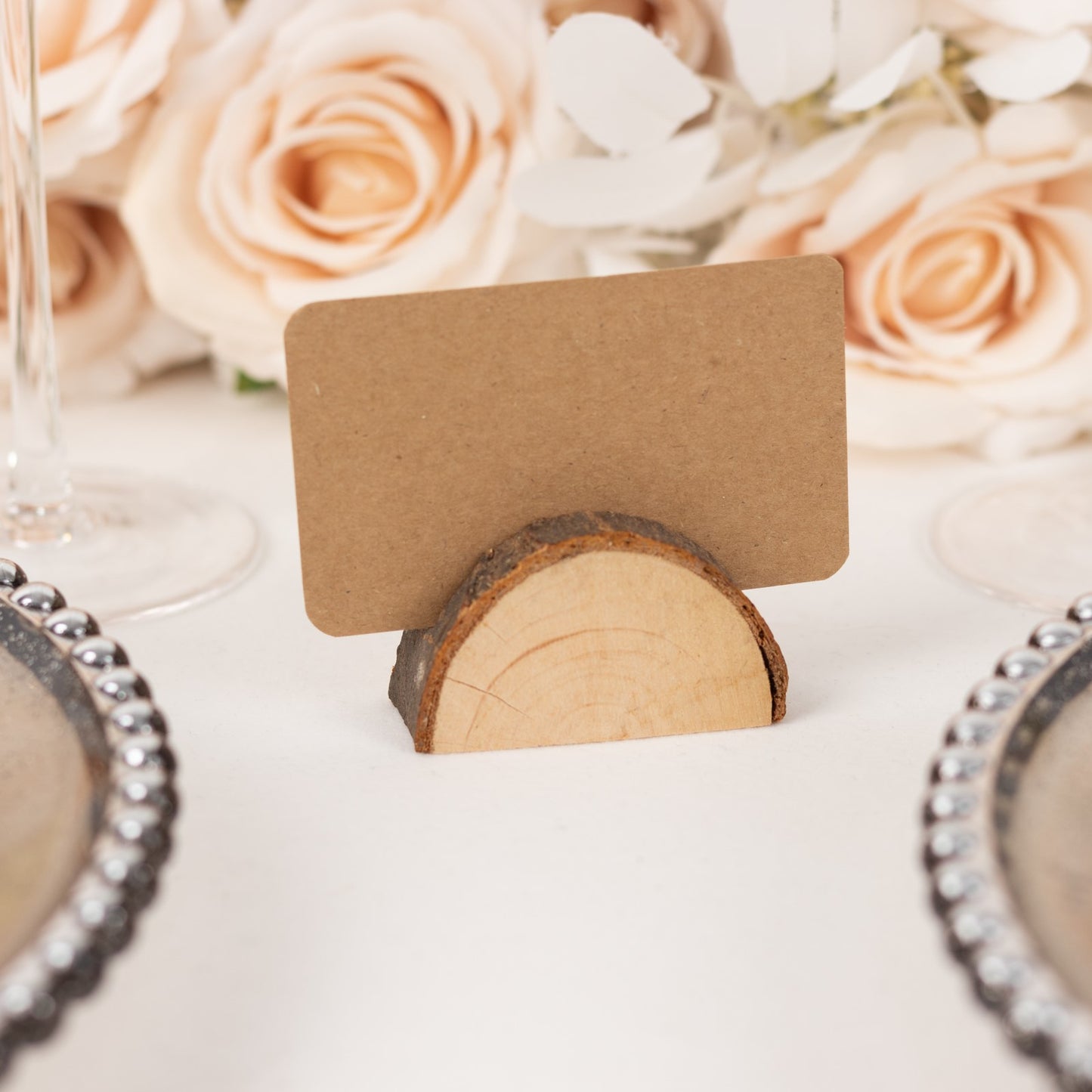 Natural wooden semicircle place card holder with brown paper card.