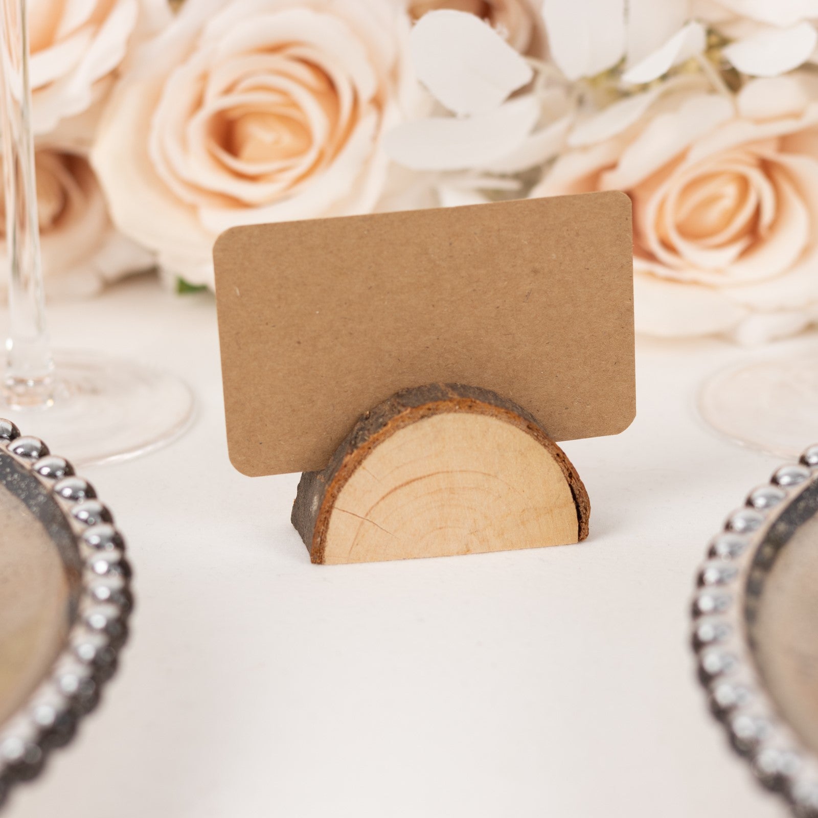 Natural wooden semicircle place card holder with brown paper card.