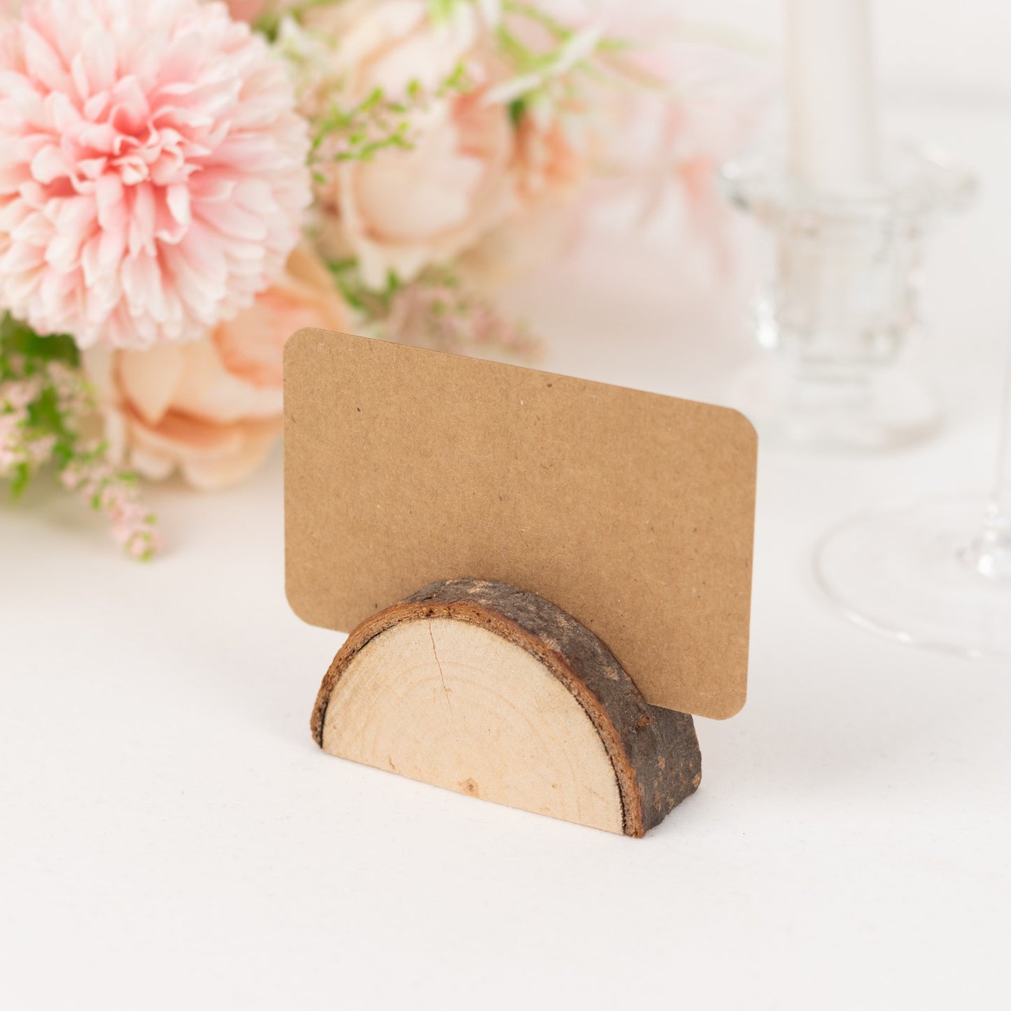Natural wood semicircle place card holder with brown paper card.