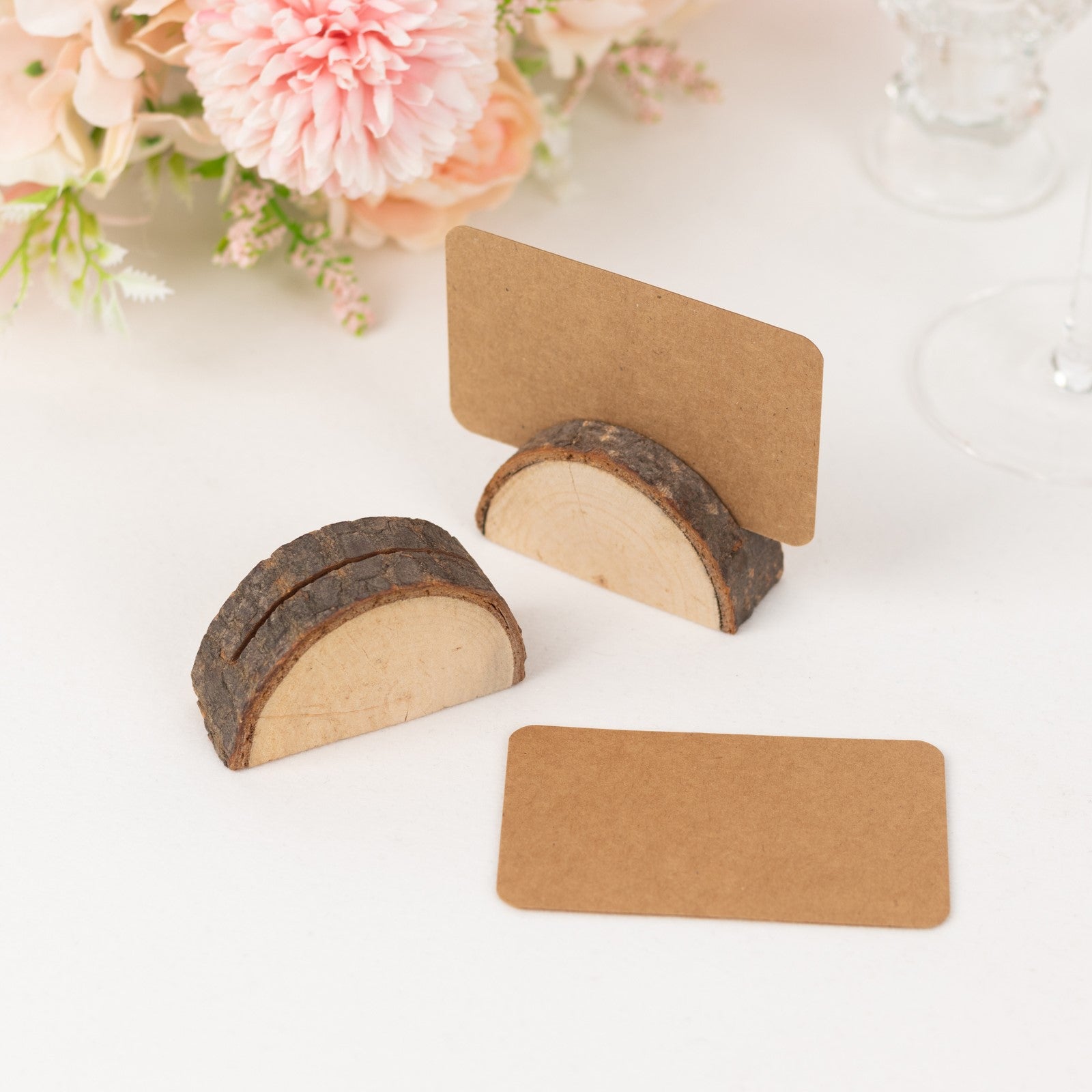 Natural wooden semicircle place card holders with brown paper cards.