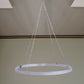 White ceiling drape hanging with stainless steel hoop hardware.