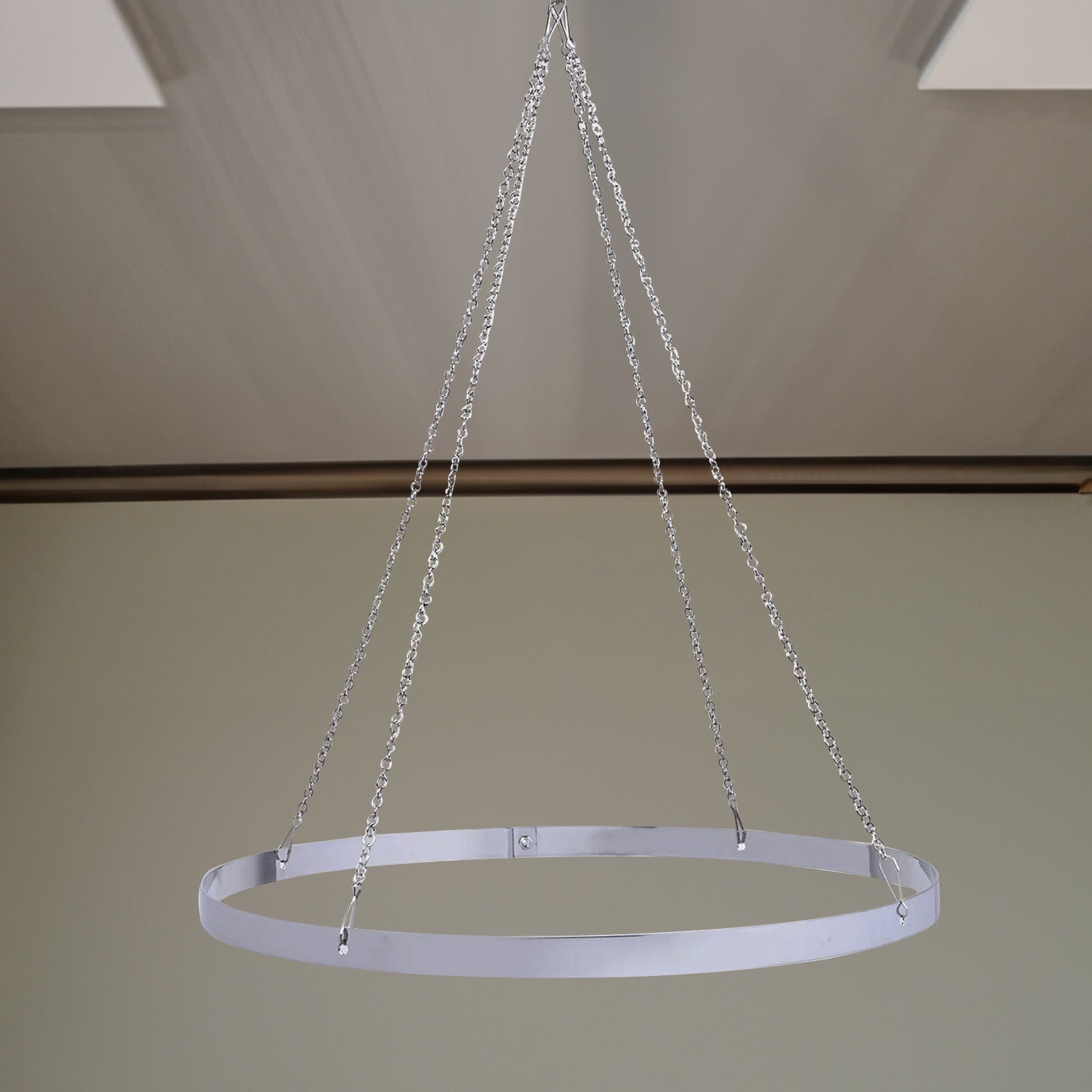 White ceiling drape hanging with stainless steel hoop hardware.