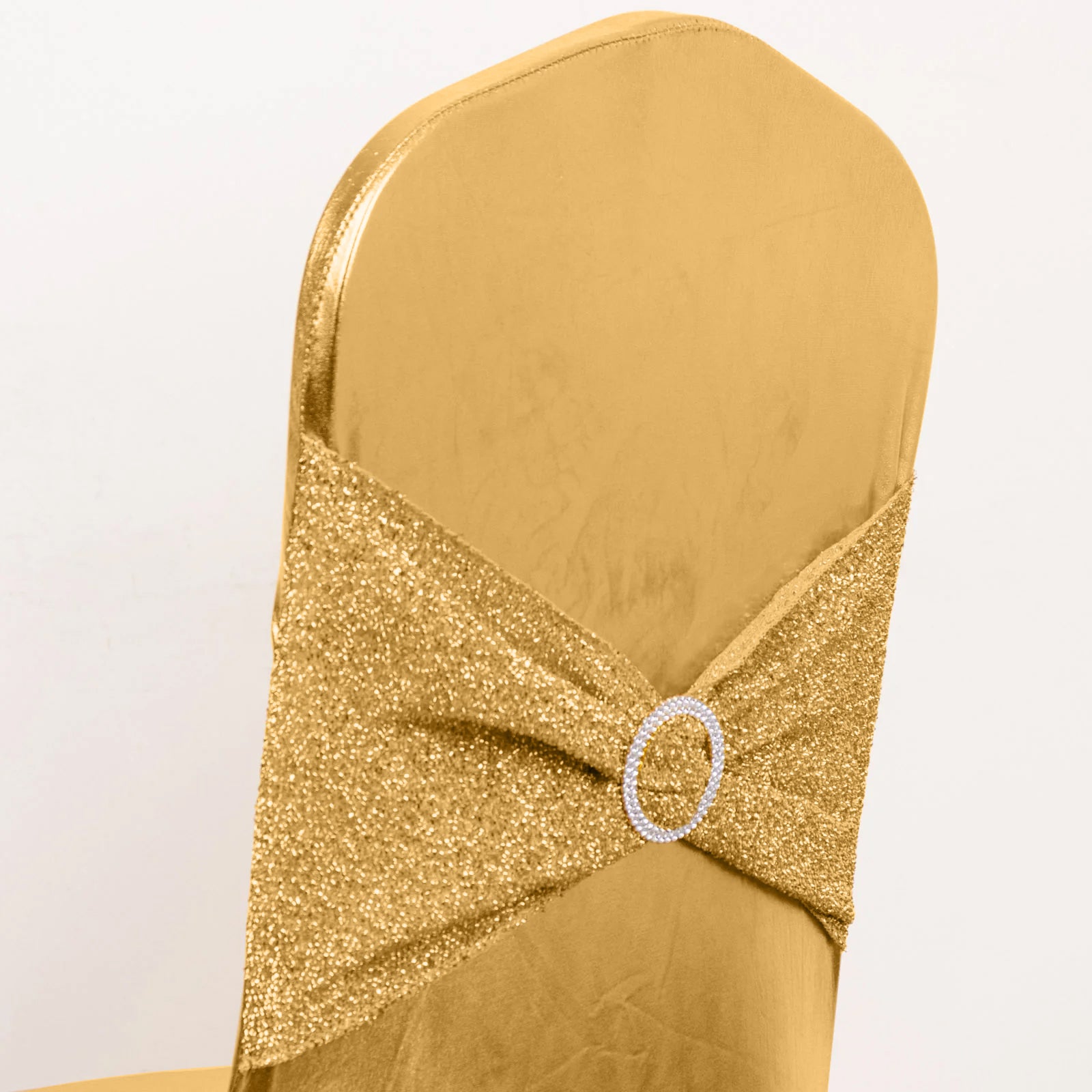 Metallic gold shimmer tinsel spandex banquet chair cover with rhinestone buckle.