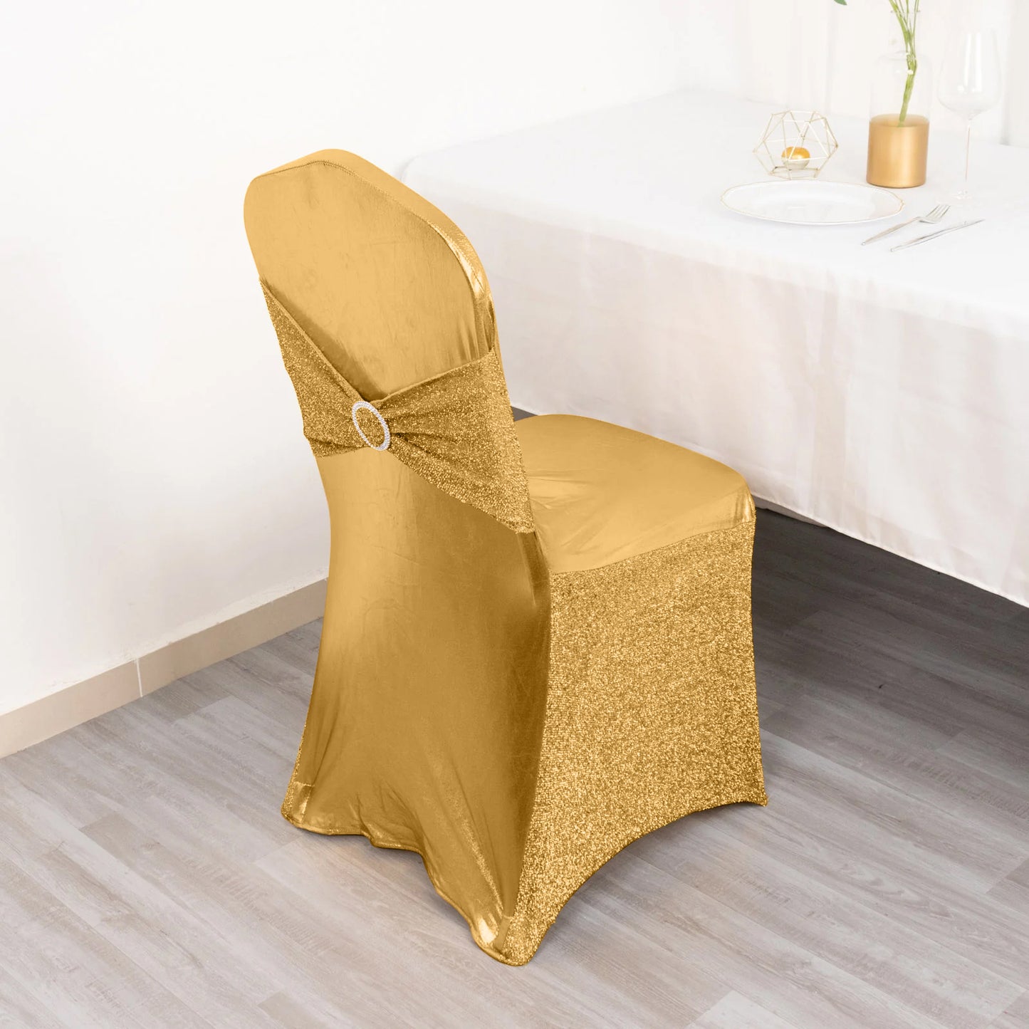 Metallic gold shimmer tinsel spandex banquet chair cover with attached sash and buckle.