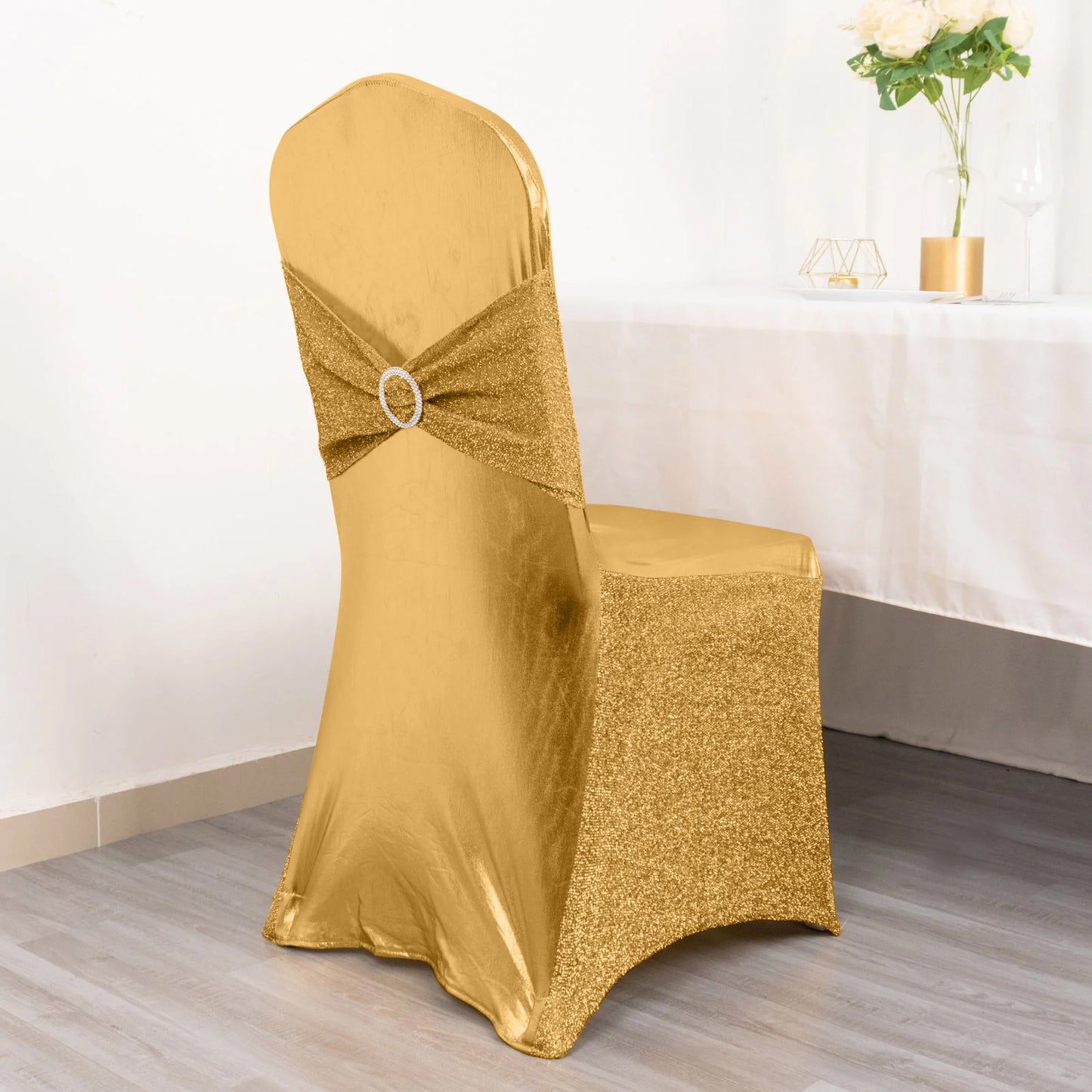 Metallic gold shimmer tinsel spandex banquet chair cover with sash and rhinestone buckle.