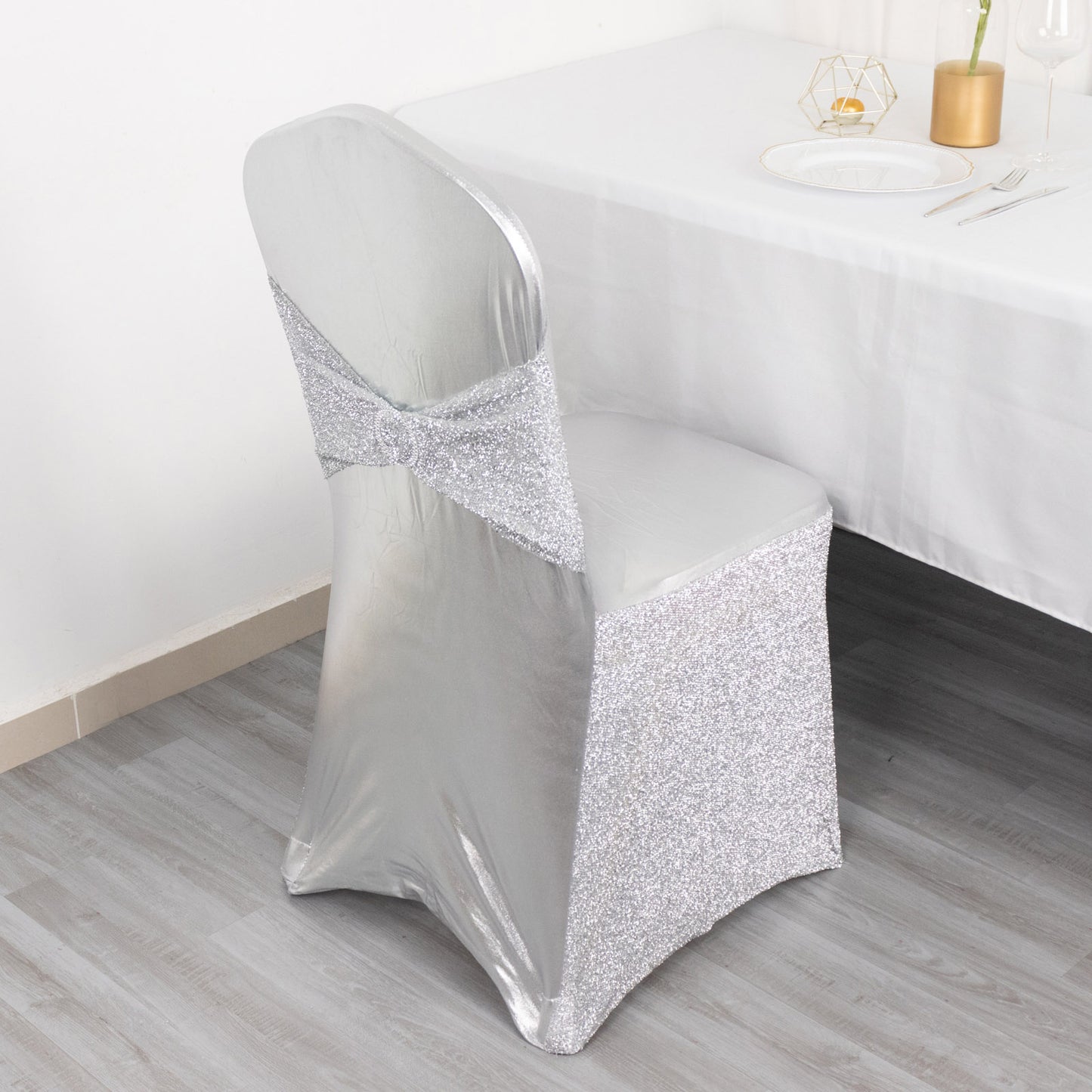 Metallic silver shimmer tinsel spandex banquet chair cover with attached sash.