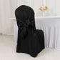 Black slip-on banquet chair cover with attached sash for event decor.