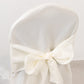 Ivory banquet chair cover with attached sash for event decor.