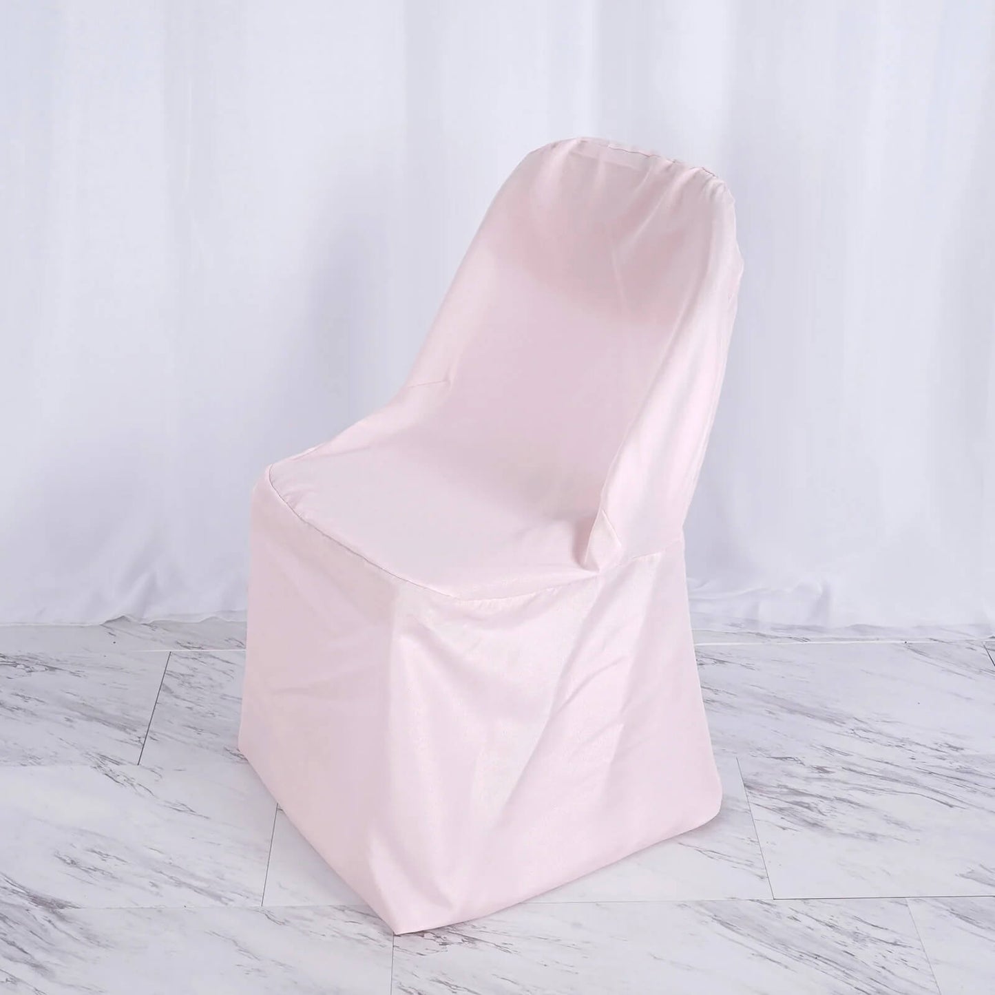 Blush polyester folding chair cover, reusable and stain resistant.